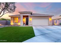 Charming single-story home featuring a manicured lawn, stone accents, and a two-car garage at 2024 E Cherry Hills Pl, Chandler, AZ 85249