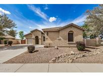 Charming single-story home with desert landscaping, an arched entryway, and a spacious driveway at 2112 E Yellowstone Pl Pl, Chandler, AZ 85249