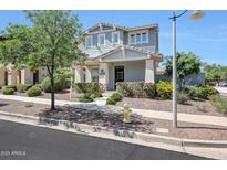 Charming two-story home with light blue siding, well-manicured landscaping, and a welcoming front entrance at 21134 W Green St, Buckeye, AZ 85396