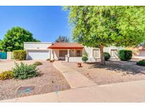 Charming single-story home featuring a well-manicured front yard with desert landscaping and a cozy covered entry at 2346 E Jasmine St, Mesa, AZ 85213