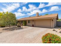Charming single-story home with a brick driveway, attached garage, and mature landscaping at 2920 W Michigan Ave, Phoenix, AZ 85053