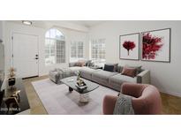 Bright living room with a gray modular sofa, marble coffee table, and large window at 3755 E Broadway Rd # 21, Mesa, AZ 85206
