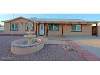 Single-story home featuring desert landscaping and a charming water fountain feature at 4132 E Sweetwater Ave, Phoenix, AZ 85032