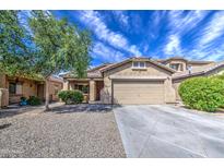 Charming single-story home featuring desert landscaping and a spacious driveway at 5342 W Maldonado Rd, Laveen, AZ 85339