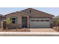 Charming single-story home with a gray door, two-car garage, and low-maintenance front yard at 5537 S 246Th Ave, Buckeye, AZ 85326