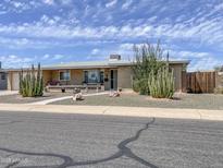 Charming single-story home with desert landscaping and a welcoming front porch, under a bright sky at 6042 E Boise St, Mesa, AZ 85205
