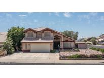 Charming two-story home featuring a well-maintained front yard, attached garage, and inviting facade at 8469 W Emile Zola Ave, Peoria, AZ 85381