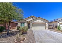 Charming single-story home with desert landscaping, a two-car garage and neutral exterior paint at 10430 E Sunflower Ln, Florence, AZ 85132