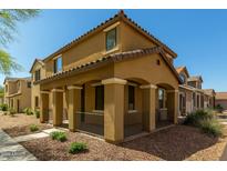 Inviting two-story home featuring a covered porch with stylish columns and low maintenance desert landscaping at 17878 N 114Th Ln, Surprise, AZ 85378