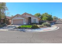 Charming single-story home with a well-maintained front yard and attached two-car garage at 18116 N Catherine Dr, Surprise, AZ 85374