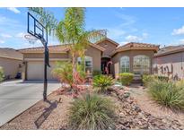 Charming single story home featuring desert landscaping, a basketball hoop, and a tile roof at 22346 N 104Th Ln, Peoria, AZ 85383