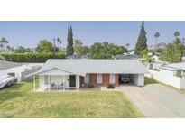 Charming single-story home featuring a carport and well-maintained front lawn at 4010 E Catalina Dr, Phoenix, AZ 85018