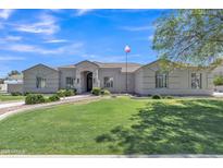 Charming single-story home with well-manicured lawn and mature trees at 4061 E Hope St, Mesa, AZ 85205