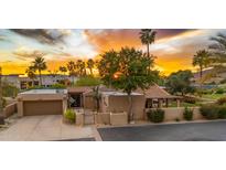 Stunning home featuring lush desert landscaping, a two-car garage, and a charming front gate at 4450 E Camelback Rd # 4, Phoenix, AZ 85018