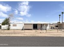 Charming single-story home with a fenced yard and covered porch, perfect for outdoor living at 6950 W Karen Lee Ln, Peoria, AZ 85382