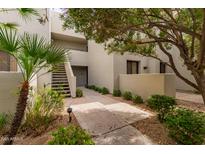 Inviting exterior with stairs leading to upper levels and lush landscaping at 7700 E Gainey Ranch Rd # 102, Scottsdale, AZ 85258