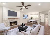 Staged living room showcasing fireplace and open concept to dining and kitchen at 7700 E Gainey Ranch Rd # 102, Scottsdale, AZ 85258