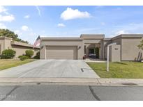 Charming single-story home features an attached garage, desert landscaping and an American flag at 7856 E Via Marina --, Scottsdale, AZ 85258
