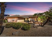 Beautiful single-story home featuring desert landscaping, a quaint porch, and a two-car garage at 9226 W Topeka Dr, Peoria, AZ 85382