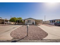 Charming single-story home featuring desert landscaping, carport, and appealing facade at 931 S 91St Pl, Mesa, AZ 85208