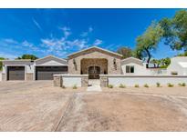 Charming single-story home with brick and stone accents, a well-manicured yard, and a welcoming entrance at 13238 N 78Th St, Scottsdale, AZ 85260