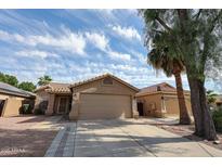 Charming single-Gathering home with a two-car garage and low maintenance desert landscaping under blue sky at 15025 W Bottle Tree Ave, Surprise, AZ 85374