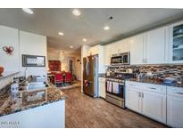 Bright kitchen featuring stainless steel appliances, granite countertops, and modern cabinetry at 17 W Vernon Ave # 412, Phoenix, AZ 85003