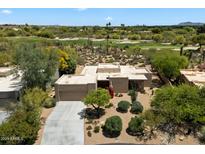 Desert home boasts golf course views, lush landscaping, and private driveway at 1725 E Staghorn Ln, Carefree, AZ 85377