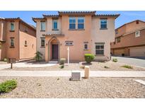 Inviting two-story home featuring desert landscaping and a charming front entrance at 2049 N 77Th Dr, Phoenix, AZ 85035