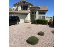 Charming two-story home with neutral stucco, well-maintained landscaping, and a two-car garage at 210 W Shannon St St, Gilbert, AZ 85233