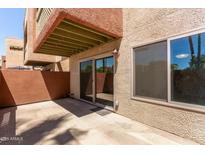 Private patio with stucco walls, sliding glass door and large window offer outdoor space at 3500 N Hayden Rd # 1603, Scottsdale, AZ 85251