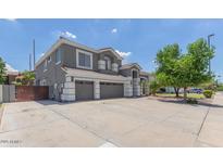 Inviting two-story home featuring a neutral color scheme, attached two car garage, and a well maintained yard at 4151 E Campbell Ave, Gilbert, AZ 85234