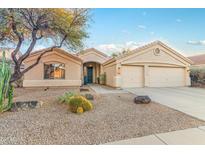 Charming desert home featuring low-maintenance landscaping, a two-car garage, and a welcoming front porch at 4611 E Red Bird Rd, Cave Creek, AZ 85331