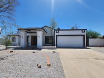 Charming single-story home featuring a well-manicured gravel yard and attached two-car garage at 6701 W Monterey Way, Phoenix, AZ 85033