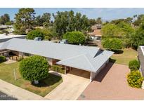 An aerial view shows this charming home and well-maintained landscaping at 10860 W Cheryl Dr, Sun City, AZ 85351