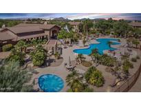 Stunning community pool with hot tub and lounge area, set against a backdrop of lush landscaping and desert sunset at 11500 E Cochise Dr # 1015, Scottsdale, AZ 85259