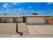 Charming single-story brick home with a two car garage and gravel landscaping at 1225 E Jacob Ln, Phoenix, AZ 85020