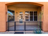 Inviting front porch with a black metal fence and tile flooring, perfect for enjoying the outdoors at 14575 W Mountain View Blvd # 12107, Surprise, AZ 85374