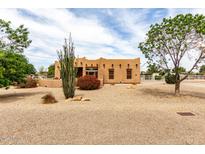 Charming tan home featuring desert landscaping, blue skies, and a welcoming ambiance at 16222 W Augusta Ave, Litchfield Park, AZ 85340