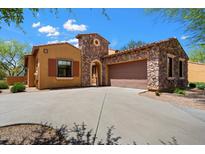 Charming stone and stucco home with a two-car garage and well-manicured landscaping at 20750 N 87Th St # 1024, Scottsdale, AZ 85255