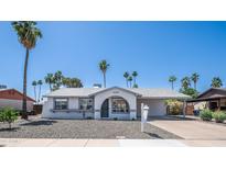 Charming single-story home featuring desert landscaping, neutral paint, and a covered carport at 2139 W Obispo Ave, Mesa, AZ 85202