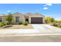 Charming single-story home features a two-car garage and low-maintenance desert landscaping at 24559 W Flores Dr, Buckeye, AZ 85326