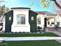 Charming home exterior with well-manicured greenery, a brick pathway and a clay tile roof at 2707 E James St, Gilbert, AZ 85296