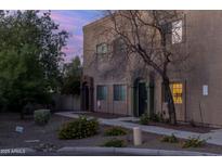 Charming two-story townhouse with beautiful desert landscaping and inviting entryway at 2826 E Tracy Ln # 3, Phoenix, AZ 85032