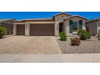 Home featuring a paved driveway, desert landscaping and a three car garage at 40470 W Agave Rd, Maricopa, AZ 85138