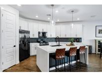 Modern kitchen features white cabinets, a large island, and stainless steel appliances at 4543 S Nebula --, Mesa, AZ 85212