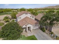 Spacious two-story home with a tile roof on a golf course lot with mature trees and a well manicured lawn at 6847 S 27Th Pl, Phoenix, AZ 85042