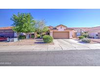Charming single-story home with a two-car garage, desert landscaping, and mature trees for a suburban feel at 9967 W Devonshire Ave, Phoenix, AZ 85037