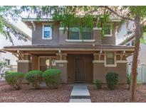 Inviting two-story home featuring a covered porch and well-manicured landscaping at 999 S Sabino Dr, Gilbert, AZ 85296