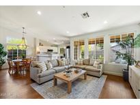 Bright living room featuring hardwood floors, recessed lighting, and large windows overlooking the backyard at 10239 E Salt Bush Dr, Scottsdale, AZ 85255